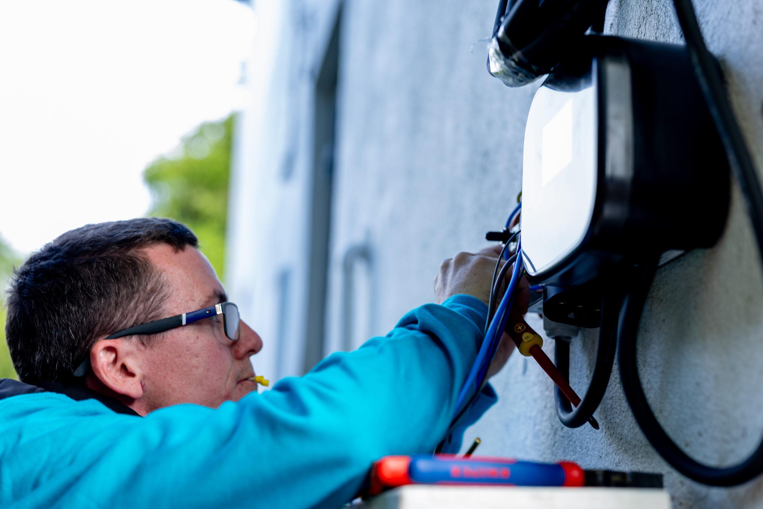 solar technician making changes to charging dock